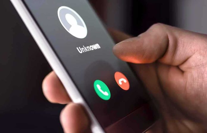Hand holding smartphone with incoming unknown call screen