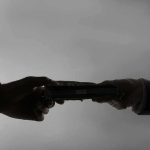 Fraud Takedown Shocks California Silhouetted hands exchanging a stack of cash