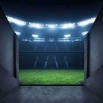 Stadium tunnel opening onto a brightly lit field