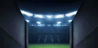 Stadium tunnel opening onto a brightly lit field