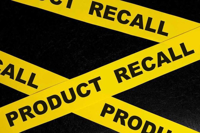 Yellow product recall tape crossing on a black surface