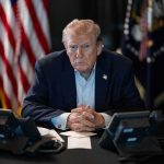 Missile KILLS An American — Trump Spoke Before He KNEW Donald Trump seated at a table between two desk phones
