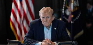 Missile KILLS An American — Trump Spoke Before He KNEW Donald Trump seated at a table between two desk phones