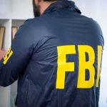 FBI agent searching a bookshelf
