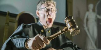 Judge slamming gavel on a wooden block