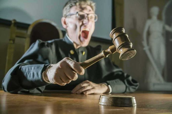 shutterstock_657581683 Judge slamming gavel on a wooden block